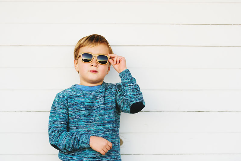 Young boy pediatric holding eyewear